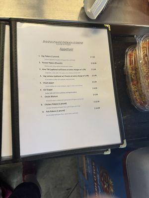 Menu at register station in the restaurant.