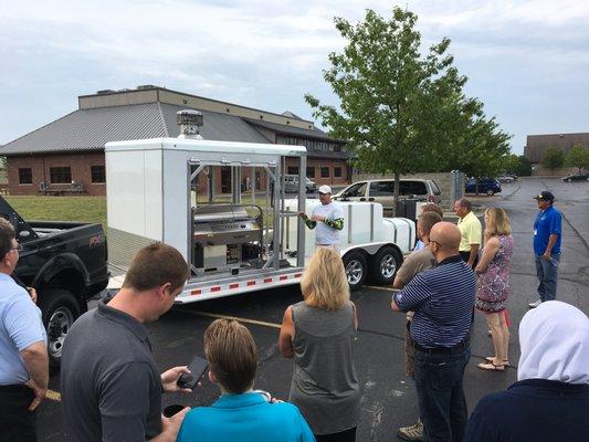 Alex shows off the power washing rig to his local BNI chapter