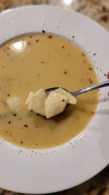 Bowl of Campbell's Chicken Wonton Soup with added red pepper flakes, black pepper and lite soy.