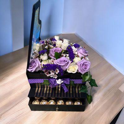 Black piano box with white and lavender roses and chocolates