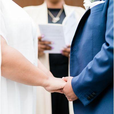 Couple hand in hand at the altar.