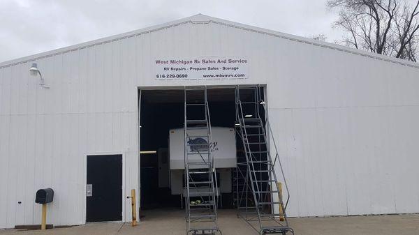 View of one of our bay doors with sign above and ladders we used to climb on roofs