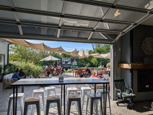 Garage doors open to the patio area