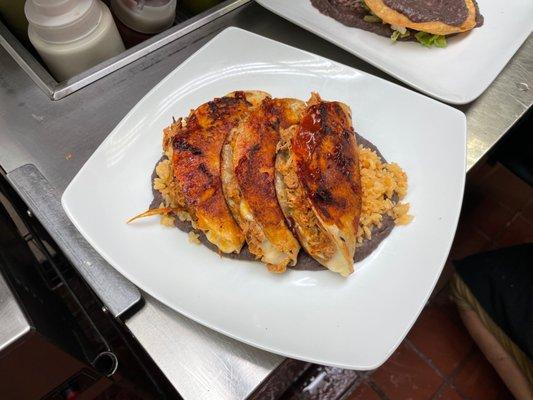 Enchiladas potosinas being plated in the kitchen.