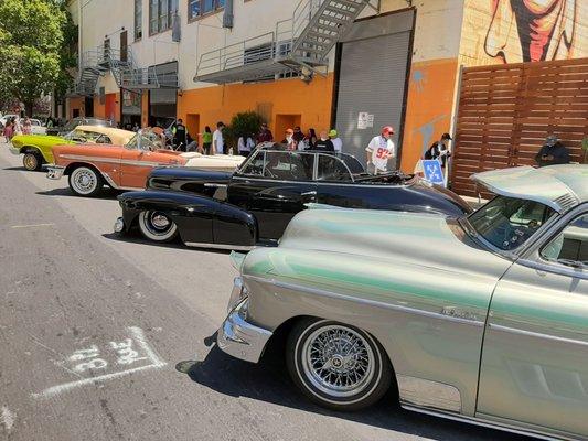 Low riders parked in front of 701 Alabama Street while volunteers take their lunch break.