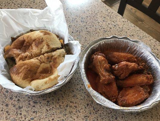 Cheesesteak on foccaccia bread and hot buffalo wings! Food is amazing and delivery was fantastic!