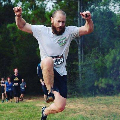 Nick leaping over an obstacle in a race