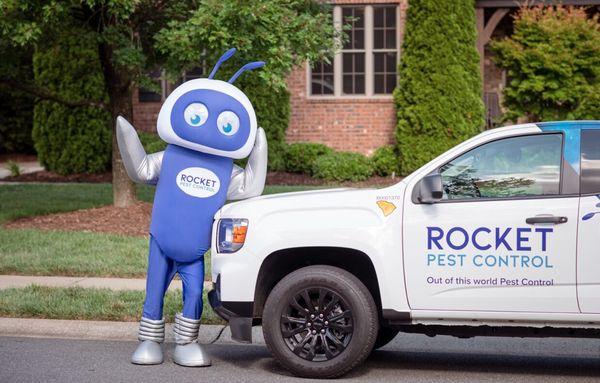 Meet Rocket Pest's friendly mascot, waving in front of our pest control service car--ready to tackle your pest problems!