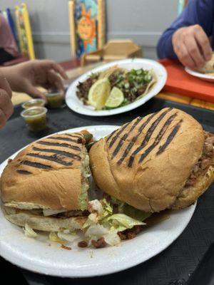 Torta al pastor and asada tacos in the back.