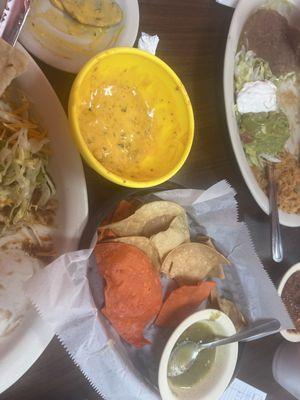 Green enchilada plate, queso and chips and Mexican plate