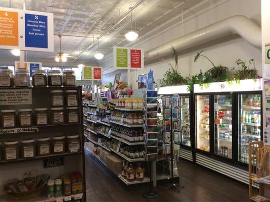 Nice light, clean interior. Bulk spices at left, drinks center, fridge and freezer at right.