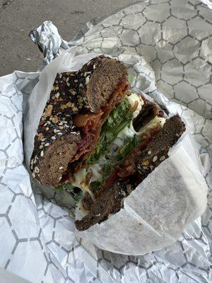 Pumpernickel everything bagel with egg, cheese, bacon and arugula.  Spicy mayo (yum) on the side