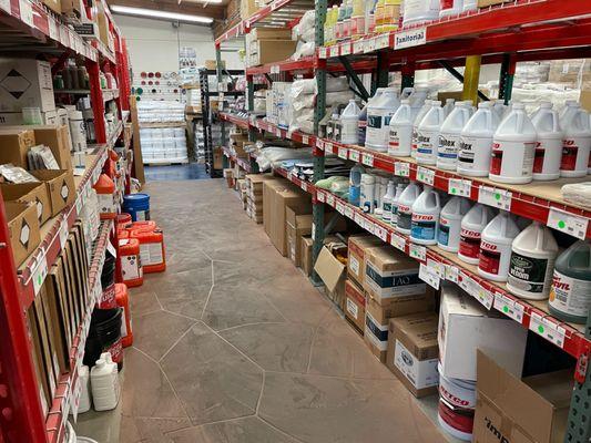 Row of shelves stocked with bottles of commercial cleaning products at Jon-Don San Diego