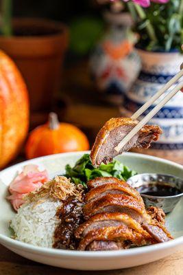 Khao Nar Ped Krob; Crispy five spiced duck breast served over rice with brown sauce, Chinese broccoli and pickle ginger.