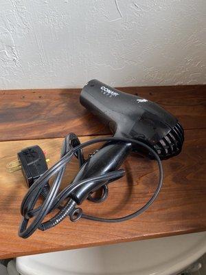 A hair dryer you would expect to find at a budget inn.