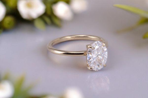 Custom oval diamond ring in 18k yellow gold by Carl Blackburn