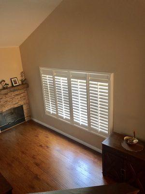 New laminate flooring, stacked stone fireplace, mantel and shutters.