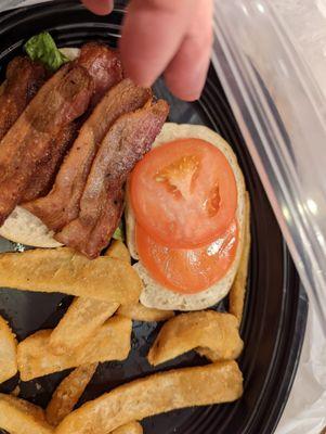 Those two little tomatoes are on a piece of sourdough bread. I don't ever think I've seen sourdough bread that tiny