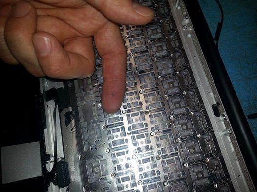 Sam at S2 was swapping out a keyboard for a Mac that was damaged by a spill.  The screws are so tiny you can barely see it!