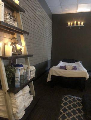 Reflexology Massage Tables in an open concept dimly lit room, soft music and real waterfall sounds.