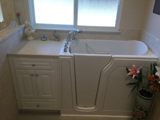 Walk-in tub with custom "side cabinet" wrapped in cultured marble.