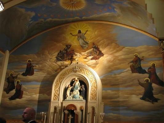 Mural and statue above altar.