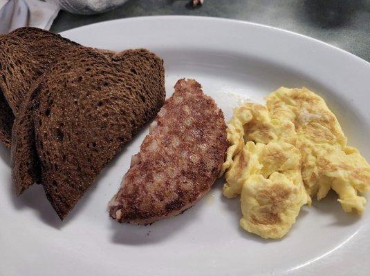 scrambled eggs, corned beef hash and rye toast from lucky loggers