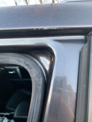 Scratch on driver door frame from forced entry without key.