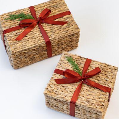 Holiday themed water hyacinth gift baskets - with red ribbon and holiday greens!