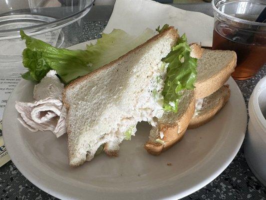 Chicken salad sandwich with lettuce and side of turkey slices