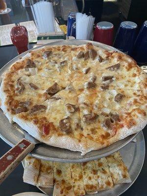 Individual size sausage and onion pizza