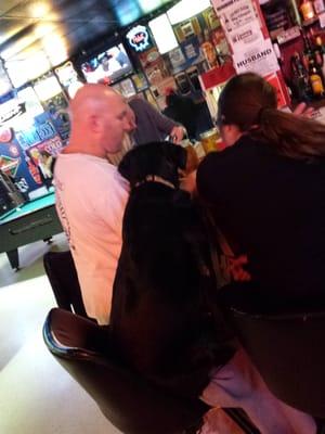 Well behaved popcorn eating black lab belly up at bar! More manners than half the customers!