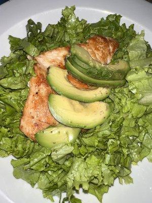 Grilled chicken breast on a bed of lettuce and some avocado. Order the chicken burger with no buns