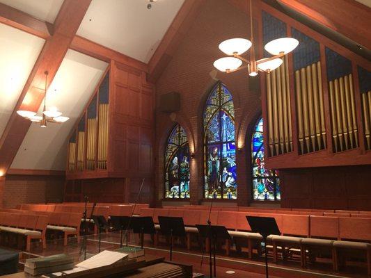 The choir loft is above the main entrance and has beautiful organ pipes and stain glass