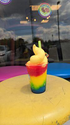 Rainbow slushie topped with pineapple dole