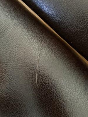 Scratches on leather furniture , that I was told would be stronger than fabric and it hasn't even been 2 weeks