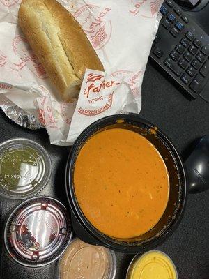 Mini chicken cheesesteak with tomato basil bisque soup and a side of cheese whiz, house sauce, pickles and chips