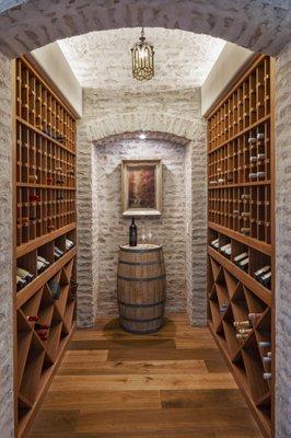 This wine cellar was custom designed to be in the middle of the home, showcasing a love for wines from around the world.