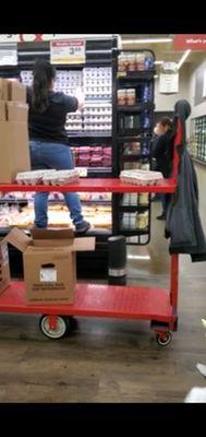 An employee standing with her nasty feet in a case containing raw chicken for sale during a global pandemic. Keep it classy. April 6th,2020.