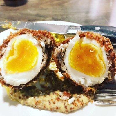 Famous Scotch Egg with house piccallili and stone ground mustard. Supposed to be a 6 minute soft boiled egg with a slightly runny center.