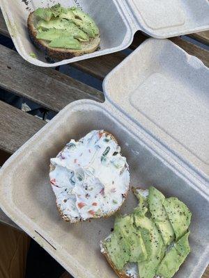 Bagel with veggie cream cheese and bagel that they made a mistake while that they were making.