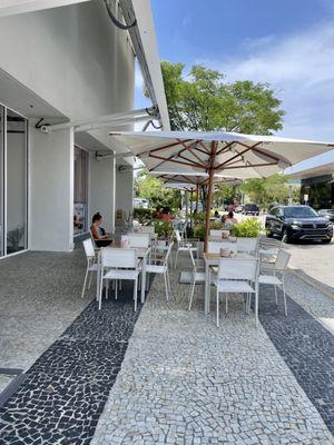 Table seating area outside the shop. Plenty of seating to relax from an afternoon of shopping, nicely shaded and great people watching perch