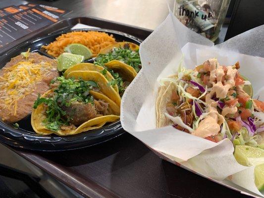 Taco plate with Rice and beans and a fish taco.