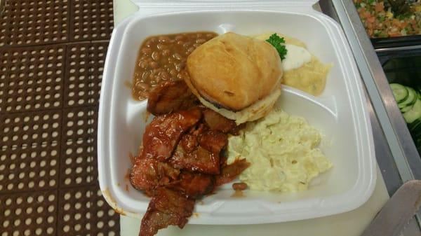 Day special plate... BBQ Brisket with baked beans, potato salad, biscuit and homemade italian corn meal with blue cheese.