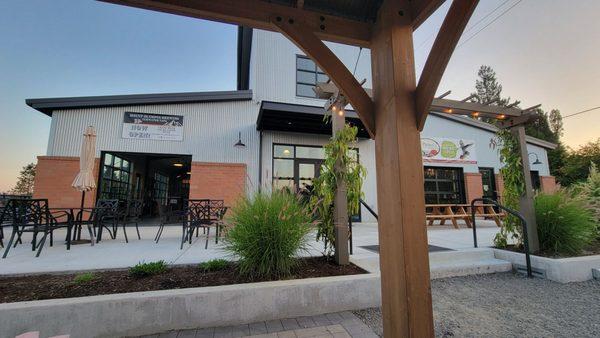 Outside patio with metal tables n chairs, picnic tables , and more.