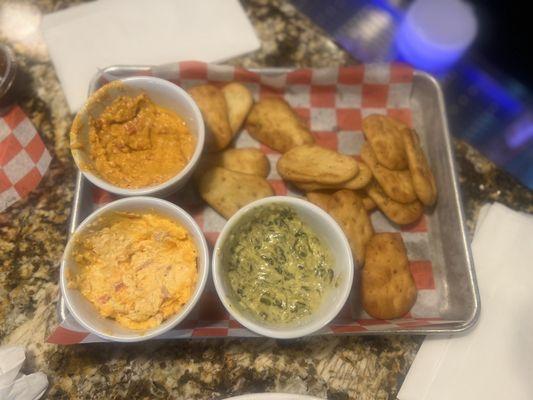 Spinach dip, pimento cheese dip and red pepper hummus with garlic pita chips so dank