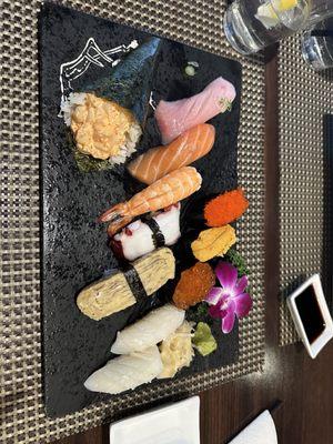 assorted à la cart sushi: Tobiko, uni, ikura, yellowtail, salmon, shrimp, octopus, tamago, squid and a scallop hand roll.