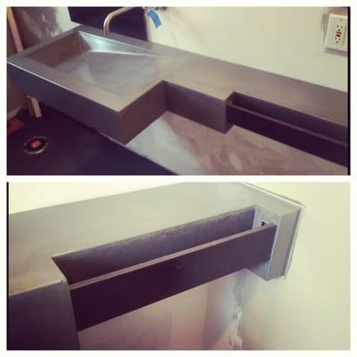 Concrete sink with steel towel bar