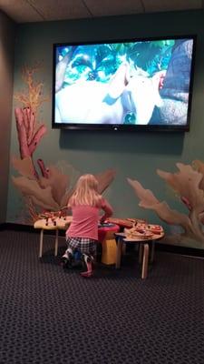 Watching a movie and playing in the waiting area