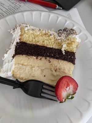 Slice of 4 layer cake. Top-Bottom: tres leches, chocolate, flan, cheesecake